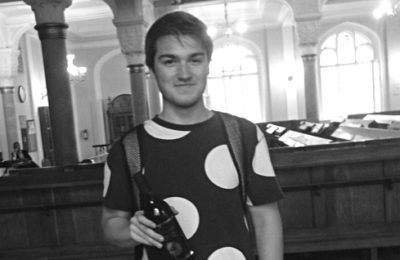 Daniel Gurevich holds the bottle of wine he won for catching a Pokemon at the Grand Choral Synagogue of St. Petersburg.