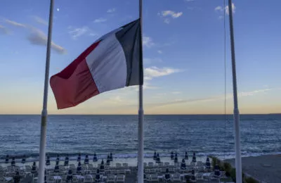 A French flag flies at half mast at an empty beach on the Promenade des Anglais on July 15, 2016 in Nice, France. (David Ramos/Getty)