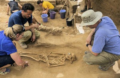 Archaeologists study one of the corpses found in the cemetery. (Leon Levy Expedition)