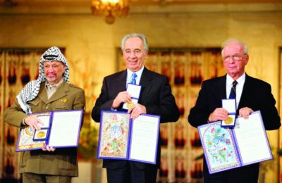 Left to right: Yasir Arafat, Shimon Peres and Yitzhak Rabin presenting their Nobel Peace Prize certificates in Oslo, Norway, 1994. (GPO)