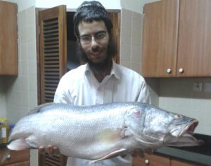 Rabbi Shmuel Notik holding a Nile perch at his home in Nairobi in 2015.