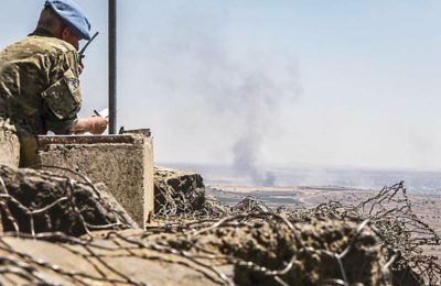 A UN observer at a lookout point near the Israel-Syria border in the Golan Heights, June 25, 2017. (Basel Awidat/Flash90)