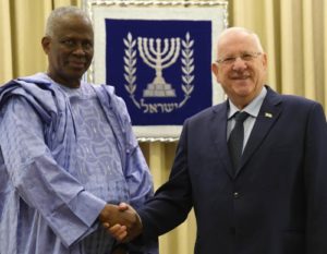 Guinea's ambassador to France, Amara Camara, meets Israeli President Reuven Rivlin, right.