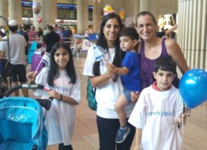 Michal Levy and her three children, with Debbie Ashkenazi, right, of IFCJ, at Ben Gurion Airport.