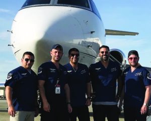 Eli Rowe, second from left, with members of his volunteer aid team in front of the airplane that was donated to make the trip to San Juan, Sept. 25, 2017.