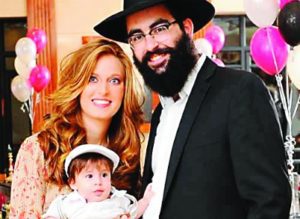 Rabbi Moishe and Yocheved Raskin, with their child.