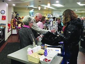 Volunteers Eileen Naiman and Ben Cohen ring up a purchase at the Rose Gift Shop.