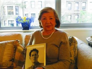 Rose Holm at her apartment holding a photo of her late husband, Joe.