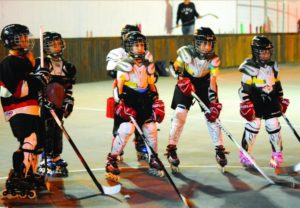 Young Arab hockey players practicing on rollerblades in Nazareth.