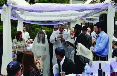 Rabbi Osher Litzman, under the canopy in black, performing a Jewish wedding in Seoul, South Korea.
