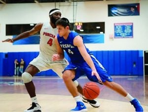 Gabriel Leitner of YU drives on a Purchase College defender, Feb. 25.