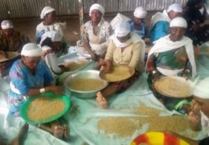 Ethiopian women in Gondar sift wheat in preparation for making matzah.