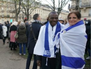 Alain Ndigal, left, and Ruth Grammens at the memorial march in Paris for Mireille Knoll, March 28.