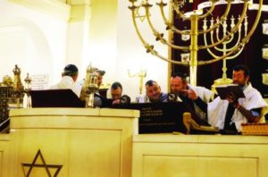 Rabbi Michael Azoulay, right, reading the Torah at the synagogue of Neuilly-sur-Seine, France, Dec. 11, 2017.