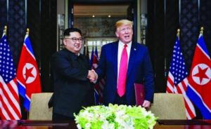 North Korean leader Kim Jong-un with US President Donald Trump (Kevin Lim/Strait Times/Handout/Getty)