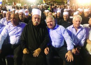 Amos Yadlin, third from left, sits with leaders of Israel's Druze community at a Tel Aviv rally against the nation-state law, Aug. 5, 2018.