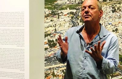 Shimon Lev, curator, in front of ‘The Mount: A Photographic Journey to Temple Mount,’ at the Tow- er of David Museum, Jerusalem.