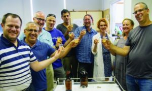 Israeli scientists toast the revived ancient beer. (Yaniv Berman/IAA)