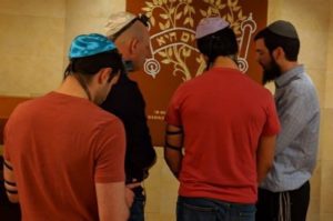 Rabbi Meir Simon, r, prays with teens following the STEM School shooting. (Chabad South Metro Denver/Facebook)