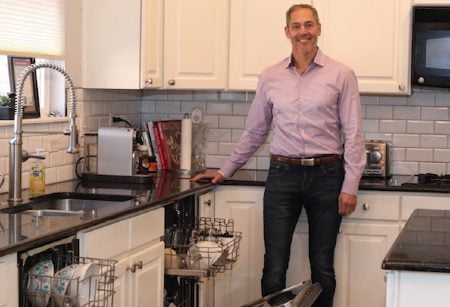 Adam Moskowitz shows off his second dishwaser, which he added after he got tired of doing milk dishes by hand.