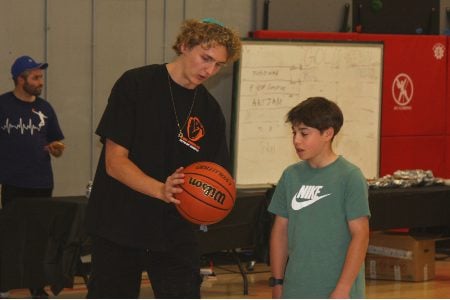 At DJDS, Ryan Turell gives tips to DJDS student Solomon Raff, Aug. 15, 2024. (Steve Mark)