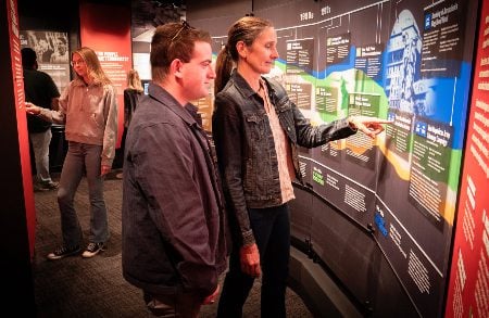 Visitors at the terrorism timeline in The CELL's new exhibit. (Courtesy)