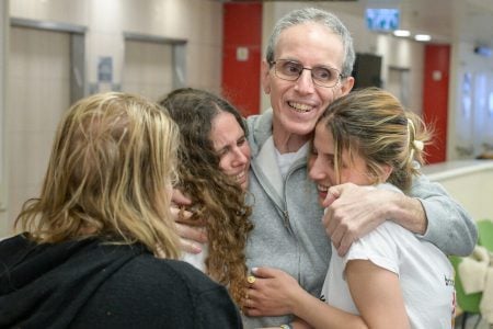 Ohad Ben-Ami is reunited with his daughters Yuli, Natalie and Ella at Ichilov Hospital. (Maayan Toaf/GPO)