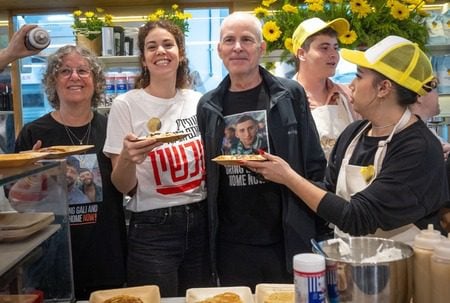 The opening of Keith Siegel pancake house, a former Israeli hostage, at Sarona market in Tel Aviv, March 26, 2025. Siegel is third from left; his wife Aviva, also a released hostage, is at left. (Miriam Alster/Flash90)