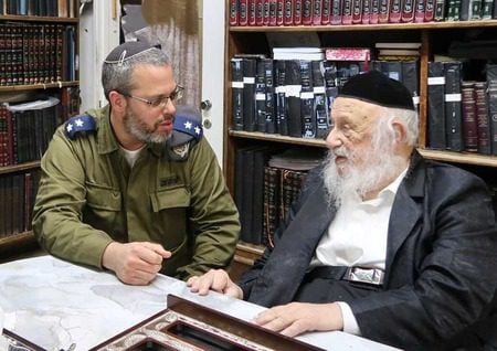 The head of the IDF Rabbinate’s kashrut division, Rabbi Neria Rosenthal, left, meets with Rabbi Berel Povarsky, right, a member of the Moetzes Gedolei Torah, the supreme rabbinical policy-making council of Agudath Yisrael.