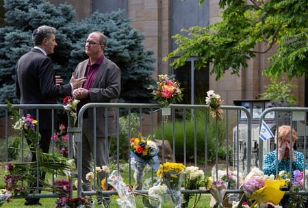 Counsul General to Israel for Pacific Southwest Israel Bachar, left, with Boulder Mayor Aaron Brockett as Karen Smith sits by a memorial for victims, June 4, 2025, in front of the Boulder County Courthouse. (Jeremy Sparig)