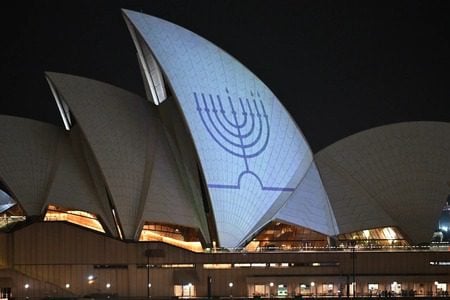 Sydney_Opera_House_Menorah The Chanukah menorah is projected onto the sails of the Sydney Opera House on December 15, 2025 in Sydney, Australia. (James D. Morgan/Getty Images)