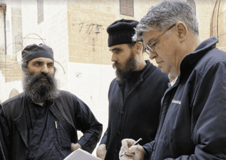 SIPP board member Bernard Amadei, an engineering professor at CU Boulder, reviewing water quality data with monks at the Mar Saba Monastery in the Kidron Basin in the West Bank, January, 2018. (Courtesy)