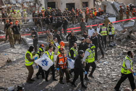 Israeli security and rescue forces operate at the scene where a ballistic missile fired from Iran struck Beit Shemesh, central Israel, causing extensive destruction and killing at least nine people, March 1, 2026. (Yonatan Sindel/Flash90)