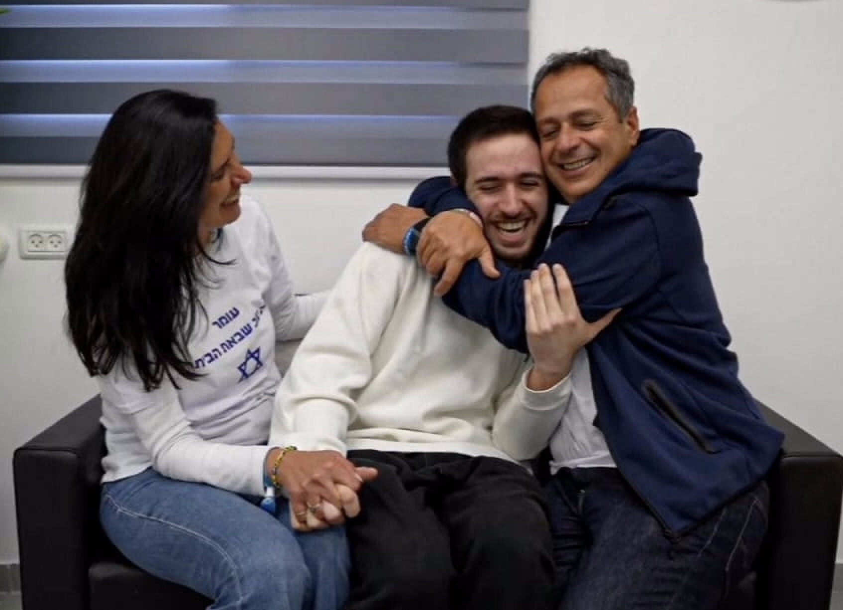 Former hostage Omer Shem Tov reunites with his parents at their first meeting point in Israel, February 22, 2025. (IDF Spokesperson’s Unit)