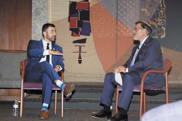 Rabbi Rick Rheins, Temple Sinai senior rabbi, engages with Elyon Levy, left, after Levy’s address on how to speak confidently about Israel. (Steve Mark)