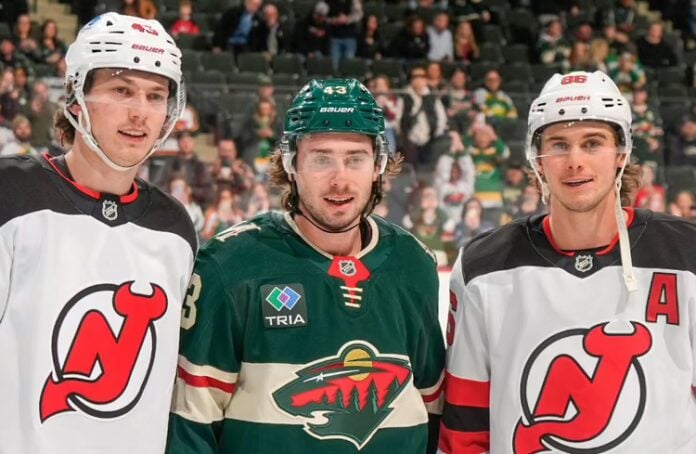 Hughes_Brothers Quinn Hughes, center, with his brothers Luke Hughes, left, and Jack Hughes, right, prior to a Devils-Wild game at Grand Casino Arena in St. Paul, Minn., Jan. 12, 2026. (Bruce Kluckhohn/NHLI via Getty Images)